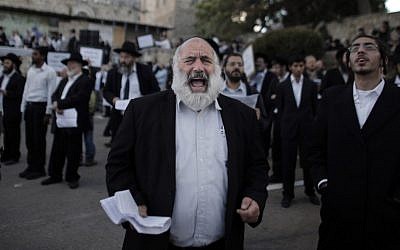 Ultra-Orthodox Jewish men protest against Pope Francis' upcoming visit to the Holy Land, on May 12, 2014 in the Old City of Jerusalem, near King David's tomb. (photo credit: AFP/Ahmad Gharabli)