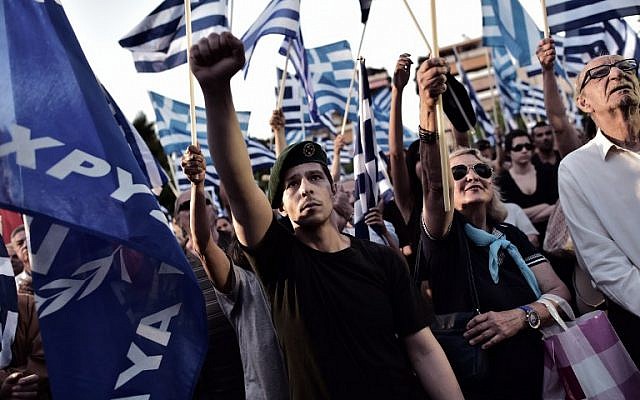 A supporter of the Greek ultra-nationalist party Golden Dawn raises his fist during a preelection rally in Athens on May 23, 2014. (AFP/Aris Messinis)