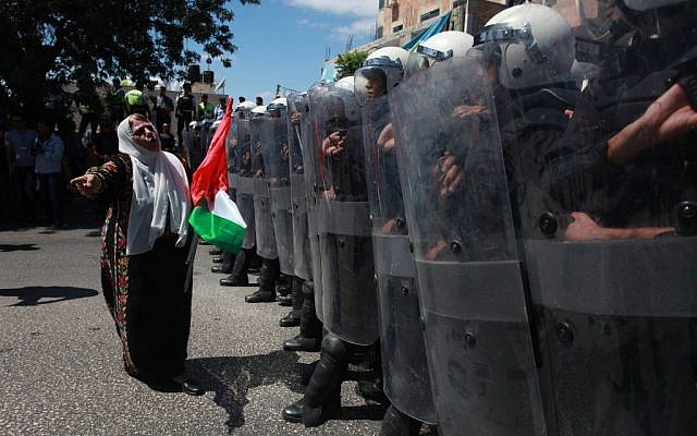 Palestinian police with riot gear stand guard as they stop supporters of the Popular Front for the Liberation of Palestine (PFLP) from reaching the headquarters of PA President Mahmoud Abbas in the West Bank city of Ramallah on September 7, 2013, during a protest against negotiations with Israel (photo credit: Issam Rimawi/Flash90)