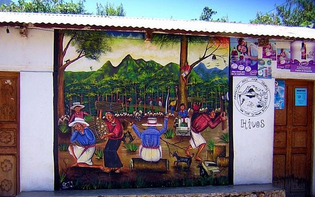 A building displaying indigenous Mayan art in San Juan La Laguna, Guatemala (Chixoy, CC-BY-SA, via wikipedia)