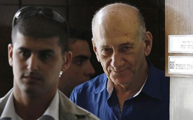 Israel's former Prime Minister Ehud Olmert leaves the Tel Aviv District Court in Israel, on Tuesday, May 13, 2014. (photo credit: AP Photo/Finbarr O'Reilly, Pool)