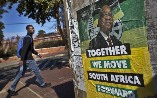 A man walks past an election poster of Jacob Zuma's African National Congress (ANC) party in the Soweto township of Johannesburg, South Africa, on Friday, May 9, 2014. (AP/Ben Curtis)