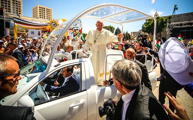 Pope Francis waving to the people after a mass in the Manger Square, next the Nativity Church, in the West Bank city of Bethlehem on May 25, 2014 (photo credit: Atta Jaber/Flash90)