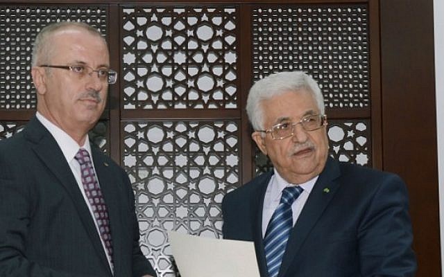 A handout picture released by the Palestinian Authority president's office shows Mahmoud Abbas (right) meeting with Palestinian Premier Rami Hamdallah (left) in the West Bank city of Ramallah. (AFP/PPO/HO)