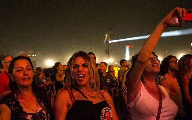 Fans cheer as The Rolling Stones perform on stage at Hayarkon Park in the Mediterranean coastal city of Tel Aviv, on June 4, 2014. (Photo credit: AFP PHOTO / JACK GUEZ)