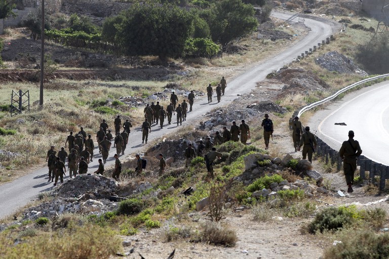 Israeli soldiers begin a search operation in the village of Halhul, near the West Bank town of Hebron, on June 29, 2014. (photo credit: AFP/HAZEM BADER)