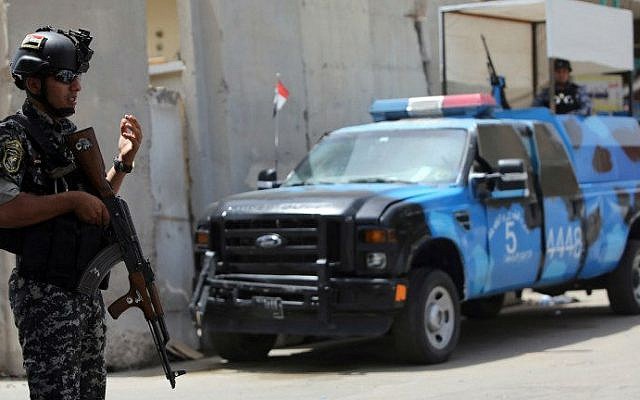 Iraqi policemen man a checkpoint in the capital Baghdad on June 12, 2014, as jihadists and anti-government fighters have spearheaded a major offensive that overrun all of Nineveh province. (photo credit: AFP/ Ahmad Al-Rubaye)