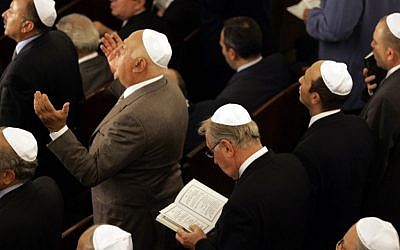 Members of Turkey's Jewish community pray at Neve Shalom Synagogue in Istanbul on October 11, 2004, during a ceremony to mark the official reopening of the synagogue (photo credit: AP/Murad Sezer)