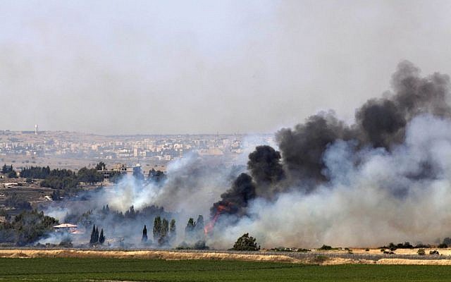 Smoke rises from a fire as a result of fighting in the the Syrian village of Quneitra near the border with Israel, as seen from an observatory near the Quneitra crossing, Thursday, June 6, 2013 (photo credit: AP/Sebastian Scheiner)