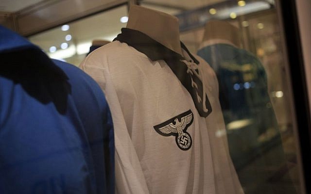A Germany 1934 FIFA Soccer World Cup team jersey is displayed among other national soccer team jerseys on a shopping mall in Salvador, Brazil, Thursday, June 19, 2014. The Nazi eagle and swastika are clearly visible on the jersey's front. (photo credit: AP/Bernat Armangue)