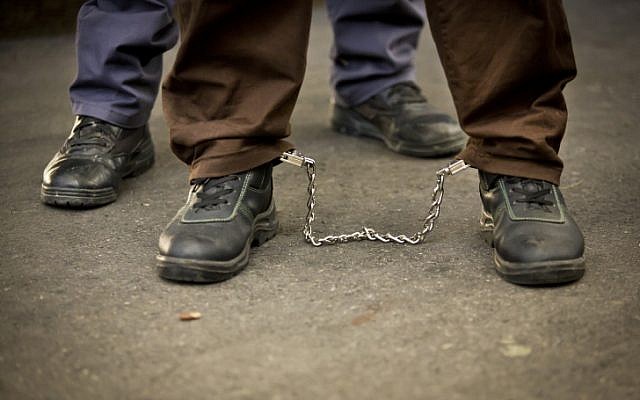 Illustrative photo of a prisoner in leg cuffs (Moshe Shai/Flash90)