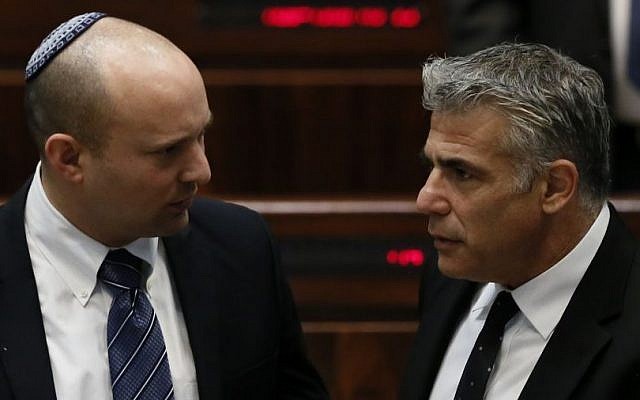 Then-Economy Minister Naftali Bennett (left) with then-finance Minister Yair Lapid in the Knesset, March 11, 2014. (Miriam Alster/Flash90)