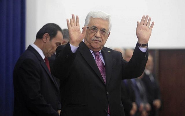 Palestinian President Mahmoud Abbas waves during the swearing-in ceremony of the new unity government in the West Bank city of Ramallah June 2, 2014. (photo credit: Issam RImawi/Flash90)