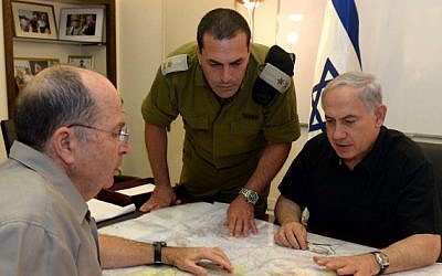 Prime Minister Benjamin Netanyahu and Defense Minister Moshe (Bogie) Ya'alon meet on June 13, 2014, as security forces search for three missing yeshiva students, feared kidnapped in the West Bank.  (photo credit: Haim Zach/GPO/Flash90)