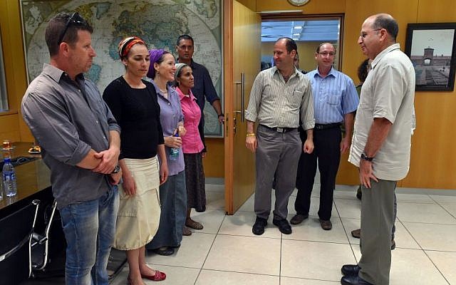 Defense Minister Moshe Ya'alon meets with the families of kidnapped Jewish teens Naftali Fraenkel, 16, Gil-ad Shaar, 16 and Eyal Yifrach, 19, at the Kirya base in Tel Aviv on Wednesday, June 18, 2014. (photo credit: Ariel Hermoni/Defense Ministry/Flash90)