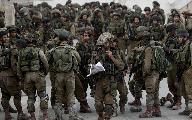 Israeli soldiers patrol in the village of Beit Kahil near the West Bank city of Hebron on June 21, 2014. (AP/Majdi Mohammed)