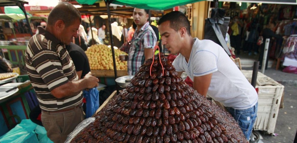 A Palestinian vendor sells dates for Ramadan at a market in Jenin, June 28, 2014. (photo credit: AP/Mohammed Ballas)