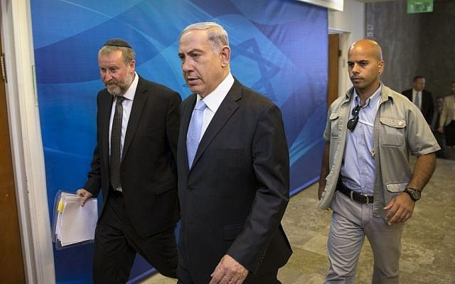 Prime Minister Benjamin Netanyahu arrives to the weekly cabinet meeting at his office in Jerusalem, Sunday, June 22, 2014. (Photo credit: AP/Baz Ratner, Pool)