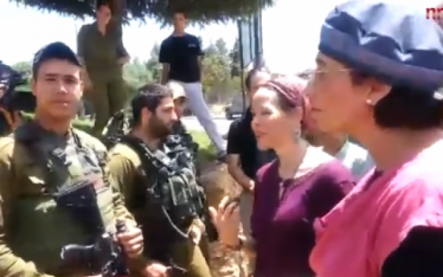 Bat-Galim Shaar (right) and Rachelle Fraenkel (second from right) speak with IDF soldiers June 29, 2014 (screen capture: NRG)
