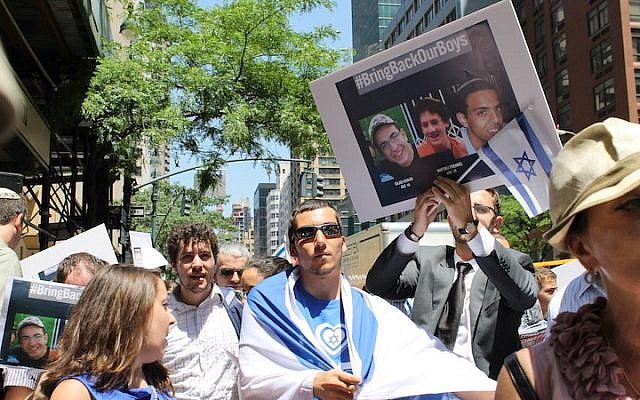 Demonstrators rally outside the Israeli consulate in Manhattan to express solidarity with three Israeli teens who were abducted in the West Bank, June 16, 2014. (photo credit: Miriam Moster/JTA)