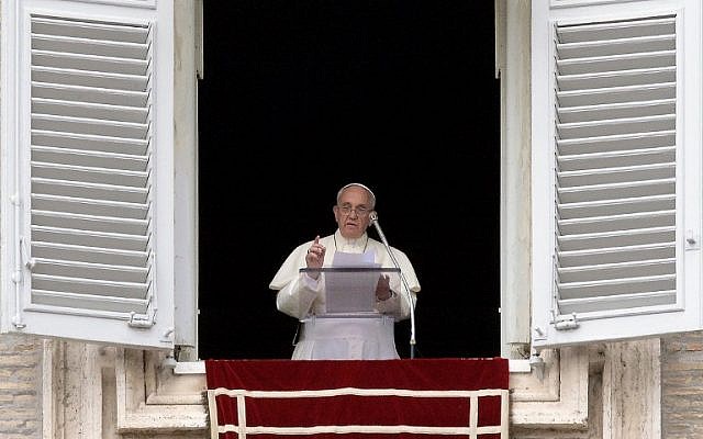 Pope Francis addresses faithful from the window of his study overlooking St. Peter's Square at the Vatican during his Sunday Angelus prayer on July 13, 2014. (photo credit: AFP/FILIPPO MONTEFORTE)