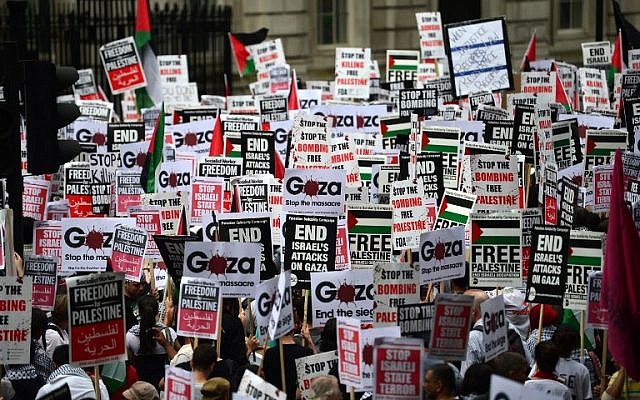 Protesters display placards and banners as they take part in demonstration against Israeli airstrikes in Gaza in central London on July 19, 2014. (photo credit: AFP/Carl Court)