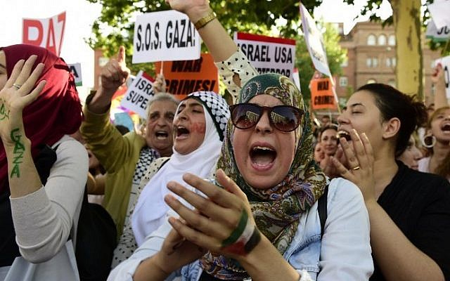 Protesters shout slogans and gesture during a demonstration against Israel's Operation Protective Edge outside the Israeli Embassy in Madrid, Thursday, July 24, 2014. (photo credit: Javier Soriano/AFP)