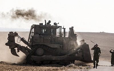 An Israeli D9 bulldozer rolls along the southern Israeli border with the Gaza Strip following Israeli airstrikes on the Gaza Strip on July 10, 2014. (photo credit: Jack Guez/AFP)