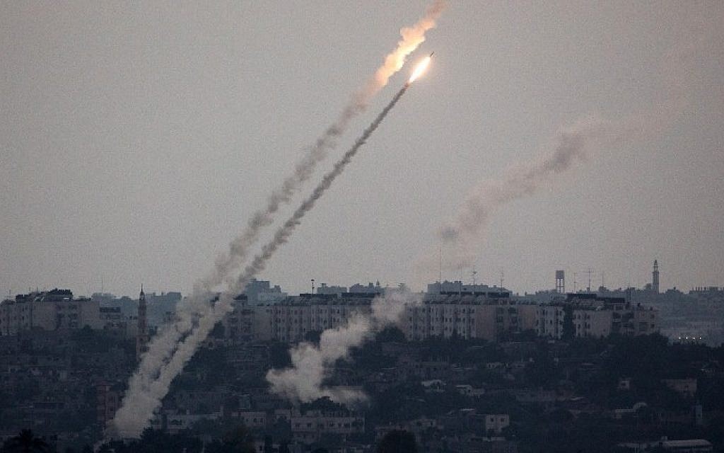 A picture taken from the southern Israel-Gaza border shows a rocket being launched from the Gaza Strip into Israel on Friday, July 11, 2014. (photo credit: Menahem Kahana/AFP)