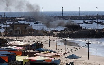 Smoke billows from a beach shack in Gaza City following an IDF strike in which four children were killed, July 16, 2014. (AFP/Thomas Coex)