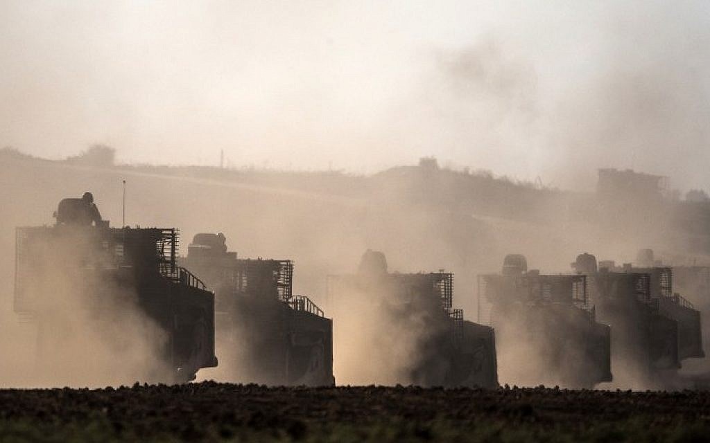 Israeli D9 bulldozers roll along the southern Israeli border with the Gaza Strip following Israeli airstrikes on the Gaza Strip on July 10, 2014. (photo credit: Jack Guez/AFP)