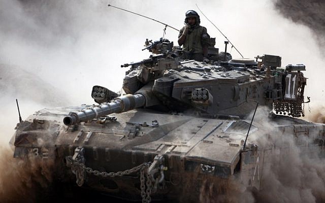 An IDF Merkava tank rolls along the border between Israel and the Hamas-controlled Gaza Strip on Monday, July 28, 2014 (AFP/DAVID BUIMOVITCH)