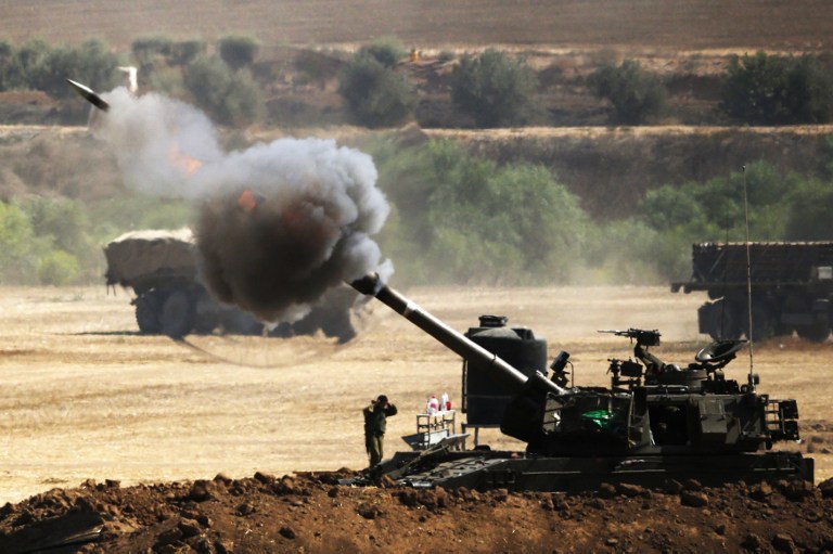 An Israeli artillery gun fires a 155mm shell towards targets from their position near Israel's border with the Gaza Strip on July 30, 2014. (photo credit: AFP/ JACK GUEZ) 