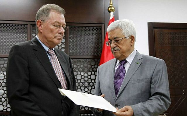 Palestinian Authority President Mahmoud Abbas (right) presents a letter to UN Special Coordinator for the Middle East Peace Process Robert Serry (left), at a meeting at Abbas's office in the West Bank city of Ramallah, on July 13, 2014. (photo credit: AFP/Abbas Momani)