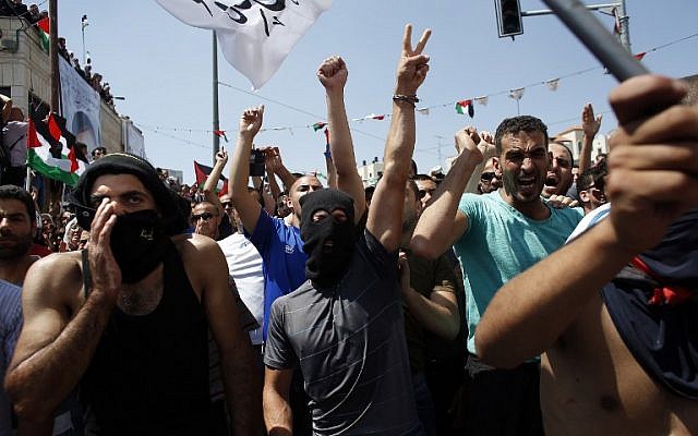 Thousands of mourners shout slogans as they gather for the funeral of Mohammed Abu Khdeir, 16, in Shuafat, in Israeli annexed East Jerusalem, on July 4, 2014 (photo credit: AFP/ Thomas Coex)