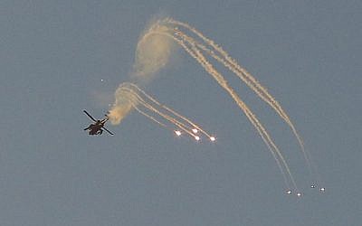 An Israeli Apache helicopter shoots a missile over the Gaza Strip on July 9, 2014, the second day of Operation Protective Edge. (photo credit: Edi Israel/Flash90) 