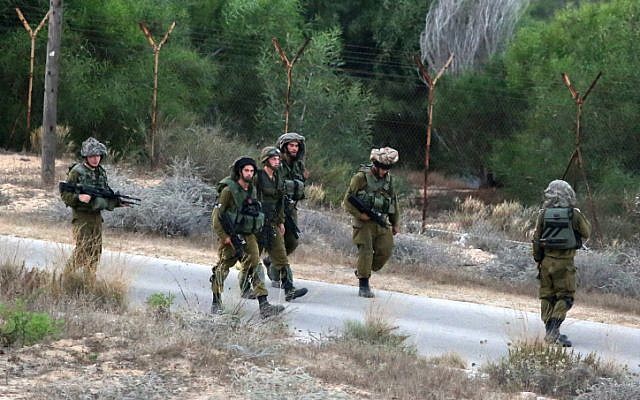 Israeli soldiers on patrol in Netiv Ha'asara on the second day of Operation Protective Edge, on July 9, 2014. (photo credit: Edi Israel/Flash90)