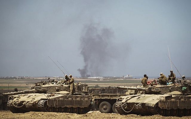 Israeli Air Force bombings in the Gaza Strip can be seen from and IDF deployment in a field near the Israeli border with Gaza on July 25, 2014 photo credit: Hadas Parush/Flash90)