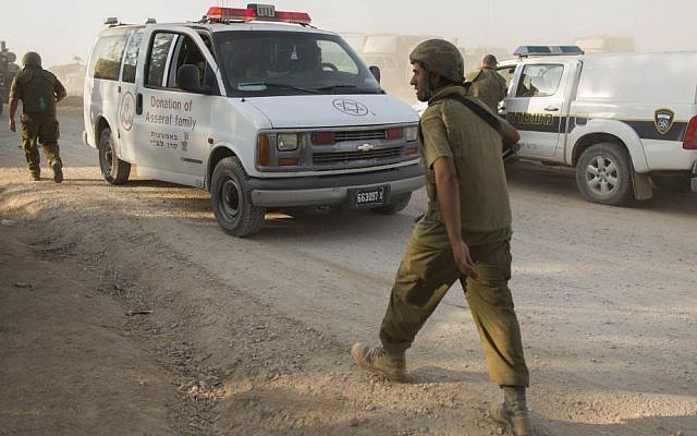 An injured Israeli soldier is evacuated by ambulance from the area near the Israeli border with the Gaza Strip, on July 28, 2014. (photo credit: Yonatan Sindel/Flash90)