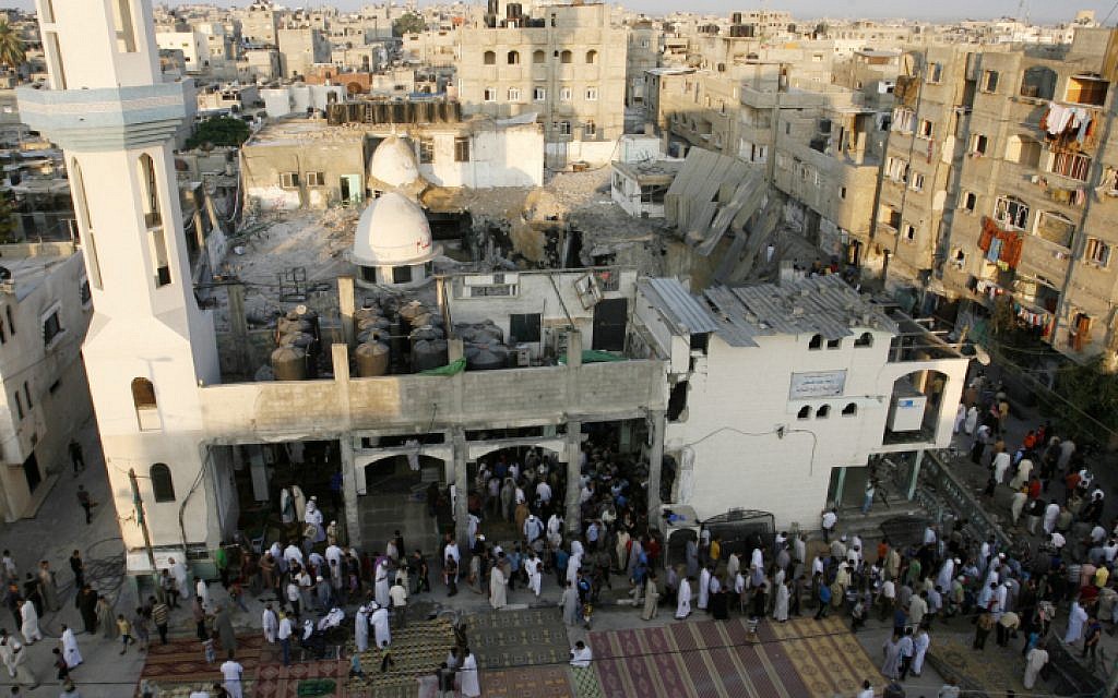 Palestinians hold Eid al-Fitr prayers at al-Faruq Mosque which was destroyed the week before in an Israeli military strike on Rafah, southern Gaza Strip, July 28, 2014. (photo credit: Abed Rahim Khatib/Flash90)