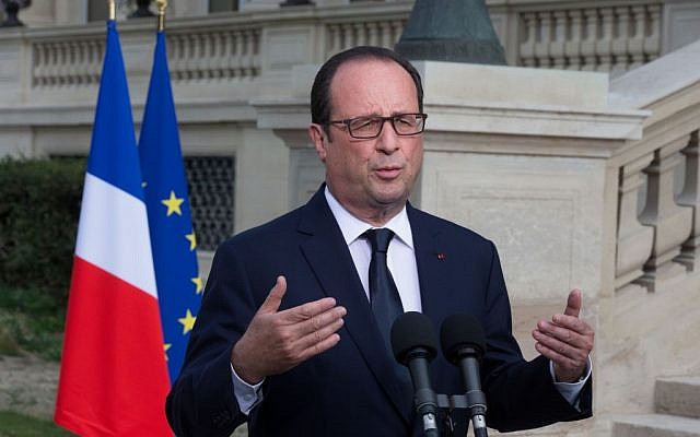 French President Francois Hollande outside the Foreign Affairs ministry in Paris, Saturday, July 26, 2014, after meeting families of the victims of Air Algeria flight crash, that killed all 118 people onboard including 54 French citizens. (photo credit: AP/Philippe Wojazer, Pool) 