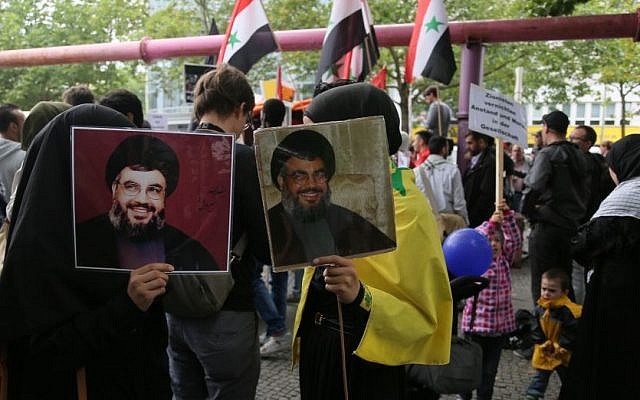Protesters hold photos of Hezbollah chief Hassan Nasrallah at Al Quds day demonstration in Berlin, July 25, 2014. (Photo credit: Micki Weinberg)
