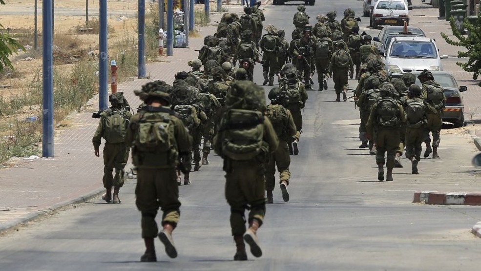 In this Monday, July 21, 2014 file photo, Israeli soldiers patrol the town of Sderot after a group of Hamas terrorists was detected infiltrating into Israel (AP/Tsafrir Abayov)