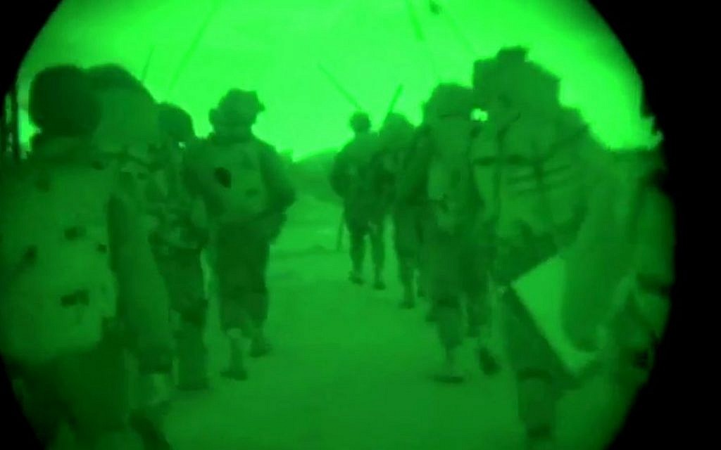 This image made from video shot through a night vision scope released by the Israeli military on Friday, July 18, 2014, shows troops during the early hours of a ground offensive in the Gaza Strip.  (photo credit: AP Photo/Israeli Defense Forces)
