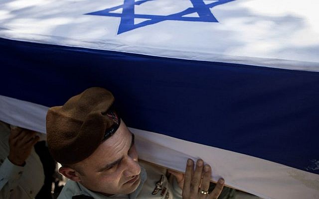 Israeli soldiers carry the coffin of Maj. Tzafrir Bar-Or, 32, one of 13 soldiers who were killed in several separate incidents in Shejaiya on Sunday, July 20, 2014, at the military cemetery in Holon, Monday, July 21, 2014. . (Photo credit: AP/Dan Balilty)