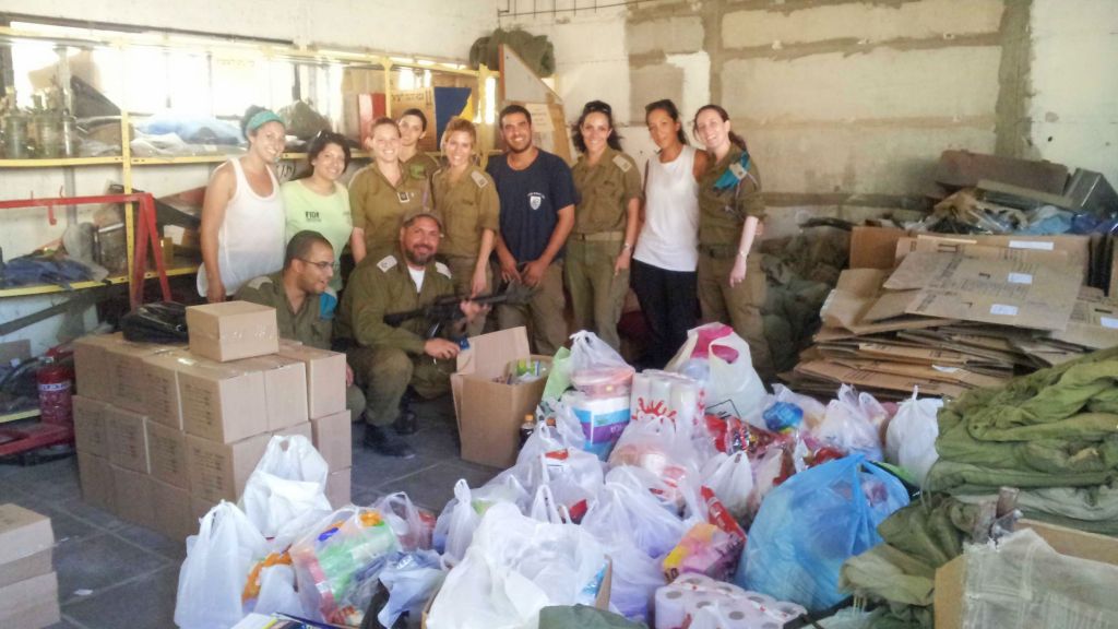 The Nefesh B'Nefesh employees with their donations on the army base. (photo credit: Debra Kamin/Times of Israel)