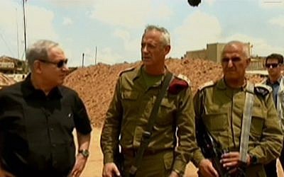 Benjamin Netanyahu, left, IDF Chief of Staff Benny Gantz, center, and GOC Southern Command Sami Turgeman speaking at a military installation in Israel's south on Monday, July 21, 2014. (Screen capture: Channel 2) 