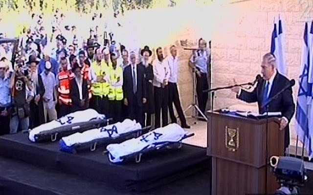 Prime Minister Benjamin Netanyahu delivering a eulogy next to the flag-draped bodies of Naftali Fraenkel, Gil-ad Shaar and Eyal Yifrach at their funeral Tuesday. (Screen capture: Channel 2)