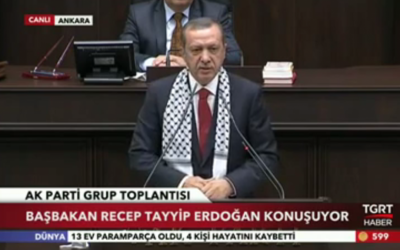 Turkish Prime Minister Recep Tayyip Erdogan wearing a keffiyeh during a July 22, 2014 AKP party meeting as a show of solidarity with the Palestinian people. (photo credit: AFP/Adem Altan)