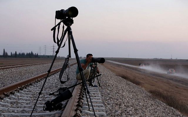 An Israeli press photographer documenting movement of IDF forces near the border with Gaza, in Southern Israel on July 23, 2014 (photo credit: Nati Shohat/Flash90)
